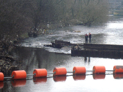 BW staff inspect the damaged weir